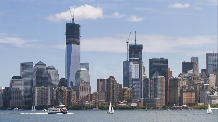 Beautiful News - Distant shot over water of New York skyscraper skyline
