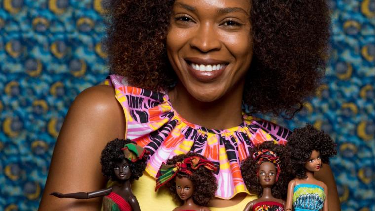 Black woman holding black dolls.