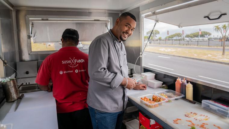 Beautiful News-Man preparing sushi in a food truck