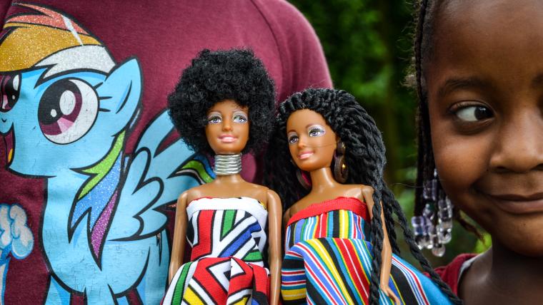 Beautiful News-Child displaying two dolls