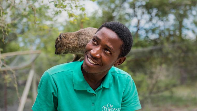 Smiling man with dassie on his shoulder