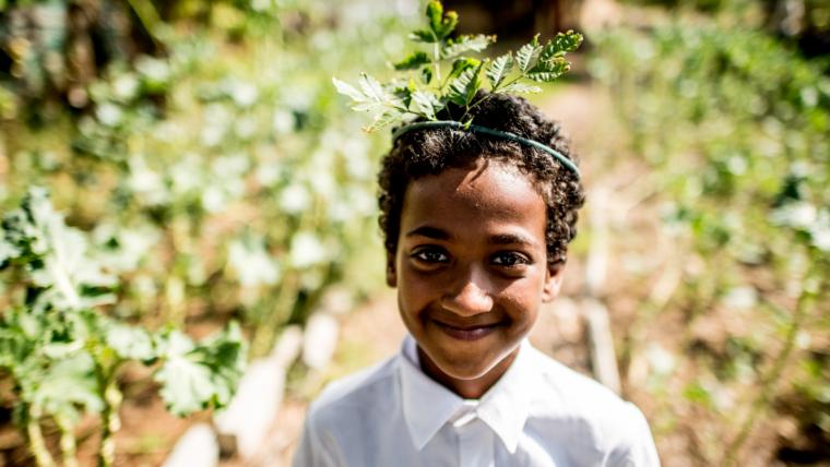 Young boy with grass crown.