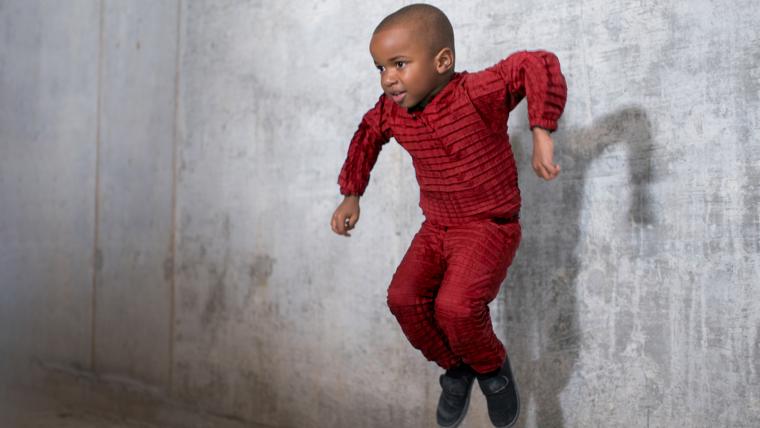 Beautiful News-Kid jumping with red pajamas on.