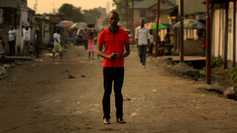 Beautiful News-Man standing still in street while other move around