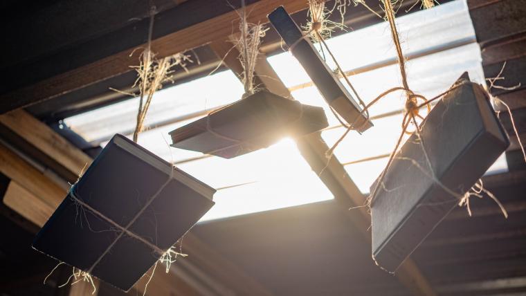 Beautiful News - Books from Hot-Spot Library hang from the ceiling with sunshine filtering through