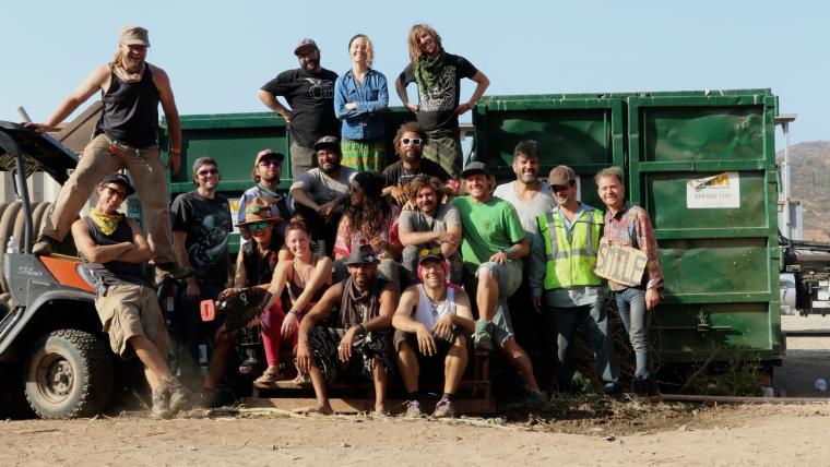 Beautiful News-People in front of waste truck.