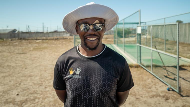 Man by cricket nets. 