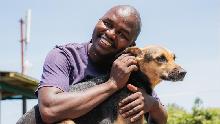 Man hugging dog