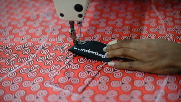 Woman's hand sewing a bag