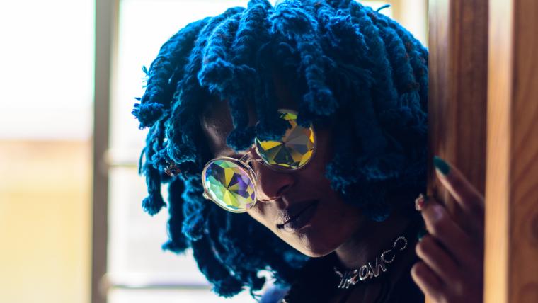 Woman with blue hair and sunglasses