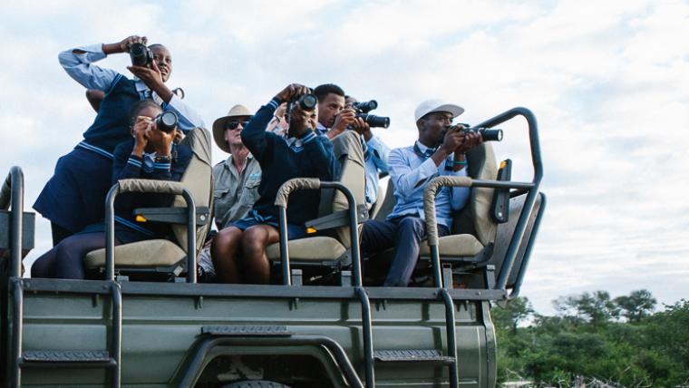 Kids taking photos on safari