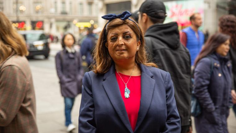 Beautiful News - Tulsi Vagjiani stands proudly on a busy sidewalk