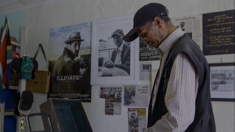 man standing by typewriter