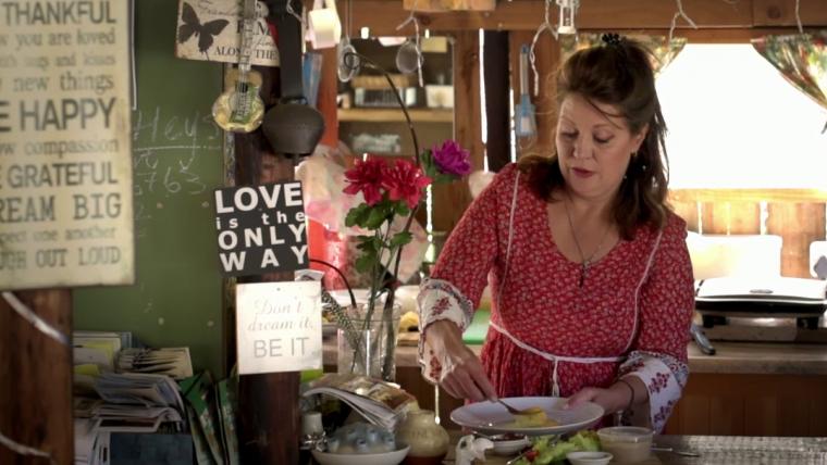 Woman placing food on a plate