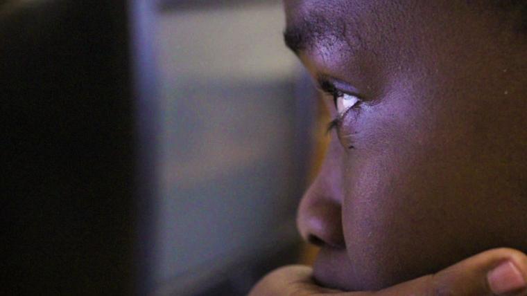 Boy looking at screen. 